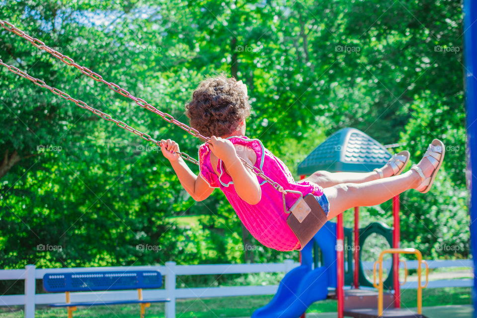 Young Swinging at a Playground 