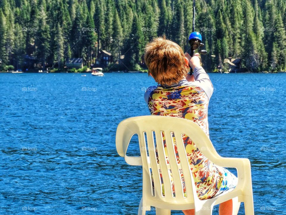 Boy Fishing On A Mountain Lake
