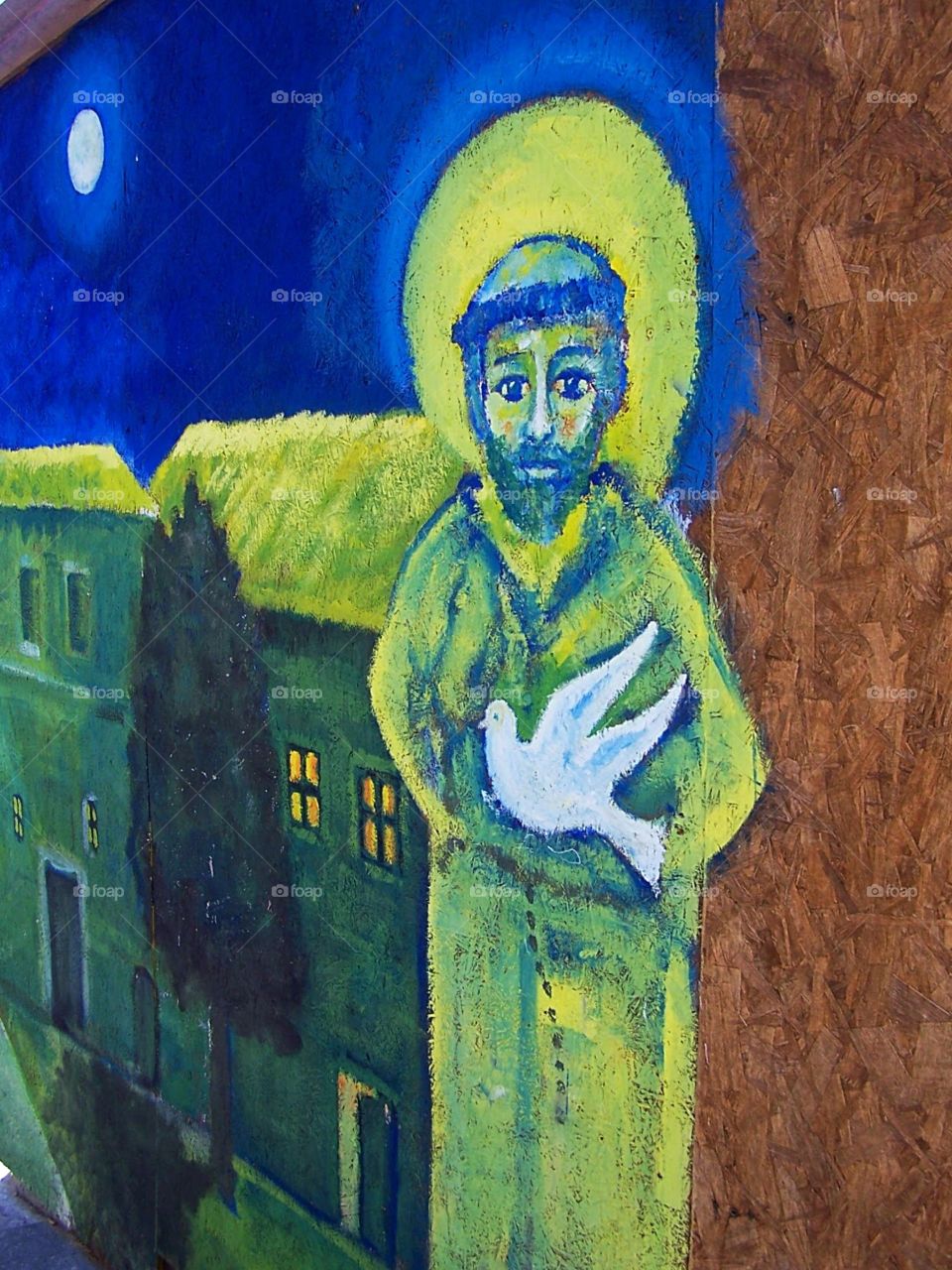 Graffiti or mural of St. Francis painted on the walls of the old city near the monastery of Saint Francis in Assisi Italy