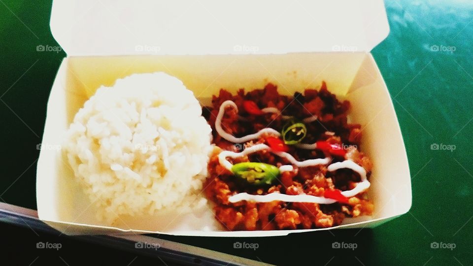 Rice meal in a box with Sisig- a traditional Philippine food.
