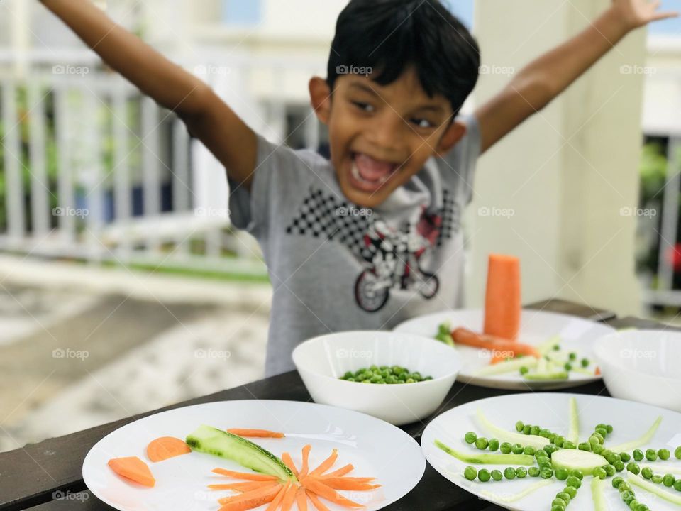 Boy having fun with vegetable shapes 