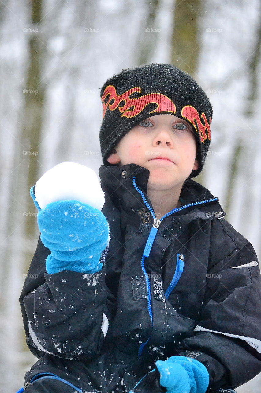 Boy holding snowball