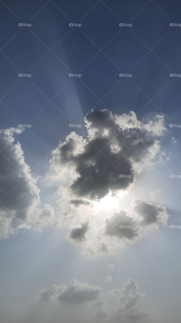sun hiding under clouds
