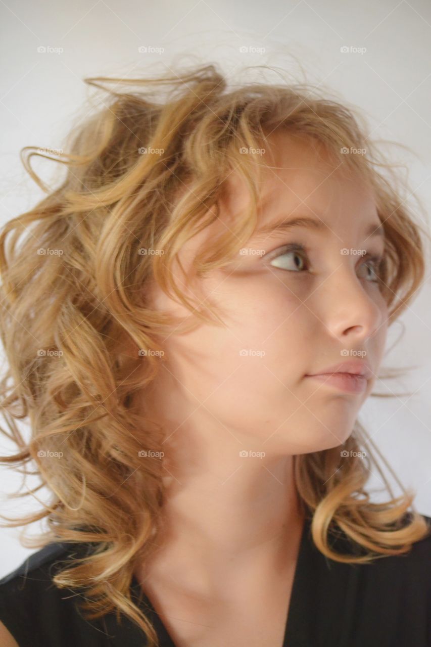 Girl in blond curly hairstyle