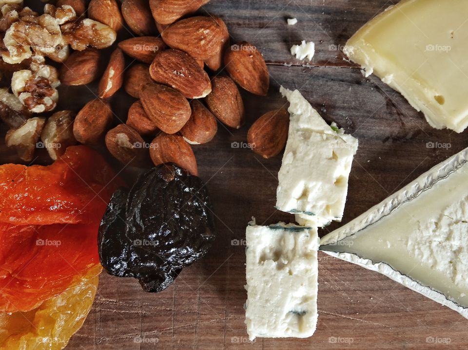 Artisanal cheeseboard with organic nuts and fruit