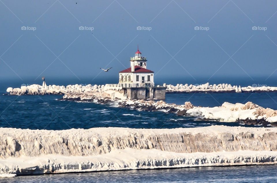 Oswego New York’s lighthouse stands at the mouth of the harbor welcoming all who visit by boat during the spring, summer and fall months.