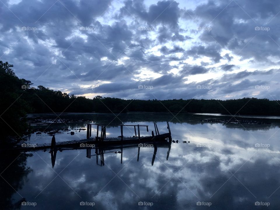 Cloudy dawn sky over bayou 