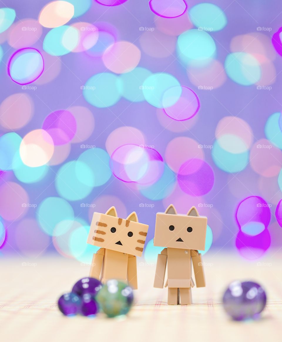 Bangkok, Thailand : March 17, 2018 - A photo of Danbo (Danboard) boyfriend and girlfriend with colorful boken background. Danbo is Japanese fictional character cardboard from Kiyohiko Azuma's manga series. Toy photography. Editorial use only. 