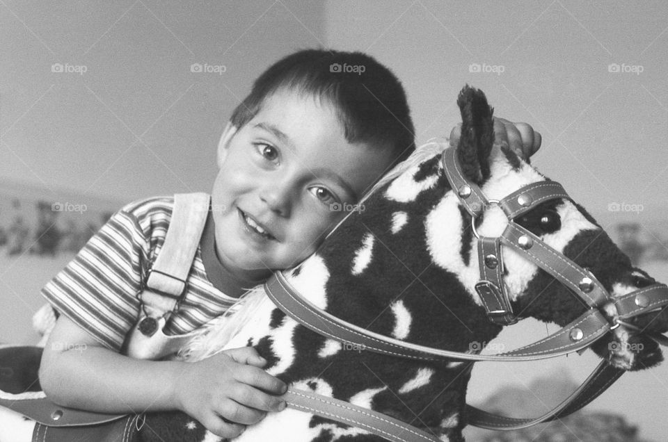 Boy riding on a rocking horse