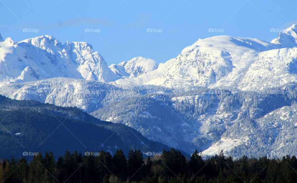 It was a beautiful sunny winter day which is rare on the Pacific North ‘wet’ Coast. It was relatively cold for our standards and cloudless which made for some awesome mountain vistas. This shot was taken from the waterfront pier. 