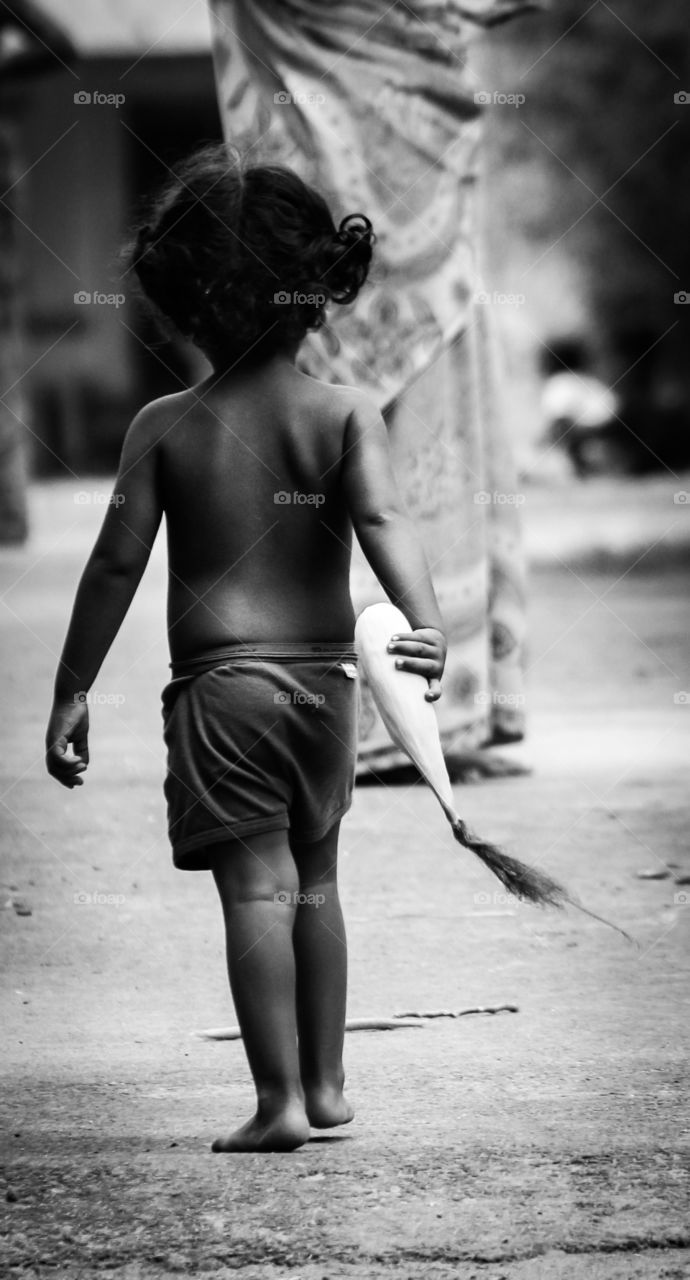 A poor boy helping mom #portraitofpoverty