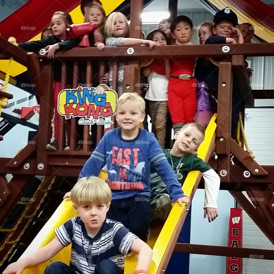 Group of children enjoying on slide