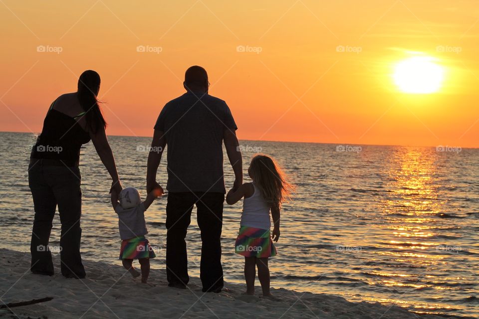 Family watching Sunset over Ocean