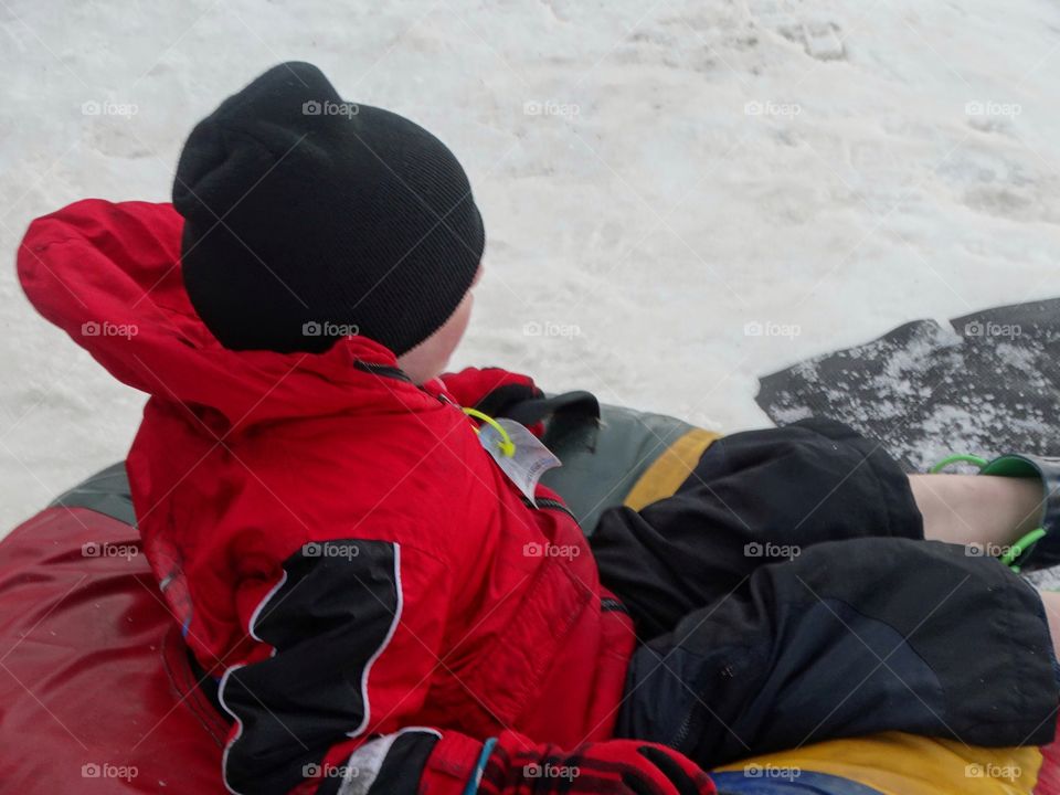 Boy Riding A Snow Sled