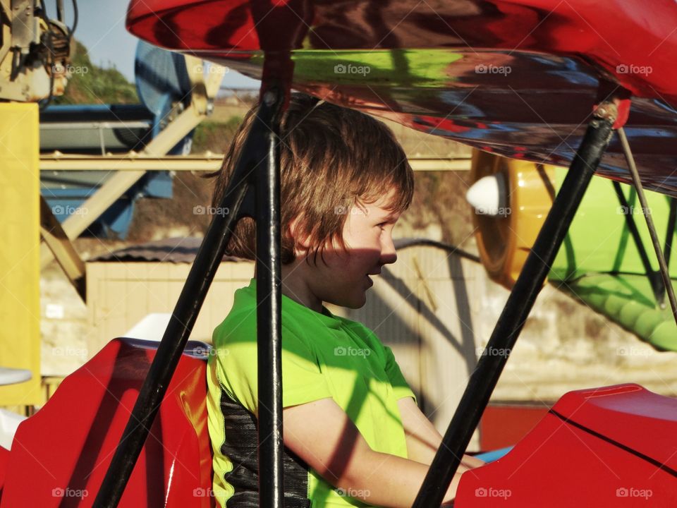 Joyful Young Boy On A Carnival Ride
