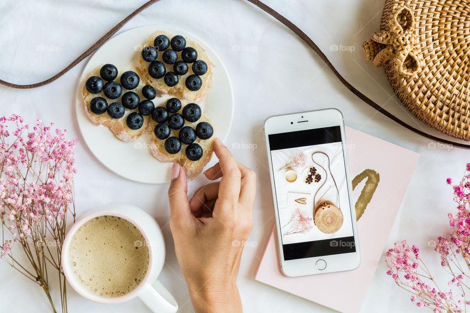 Flat lay with breakfast and mobile phone 