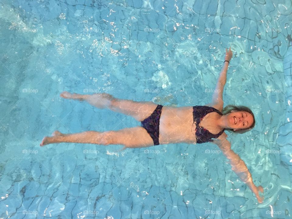 Woman laying underwater swimming