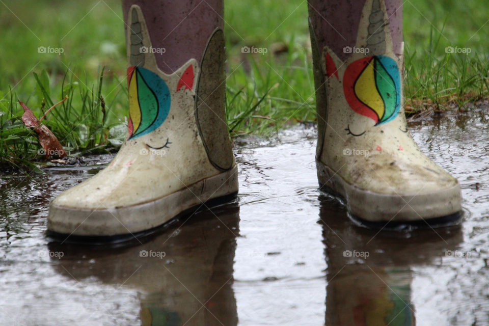 Rainboots with unicorns in the puddle