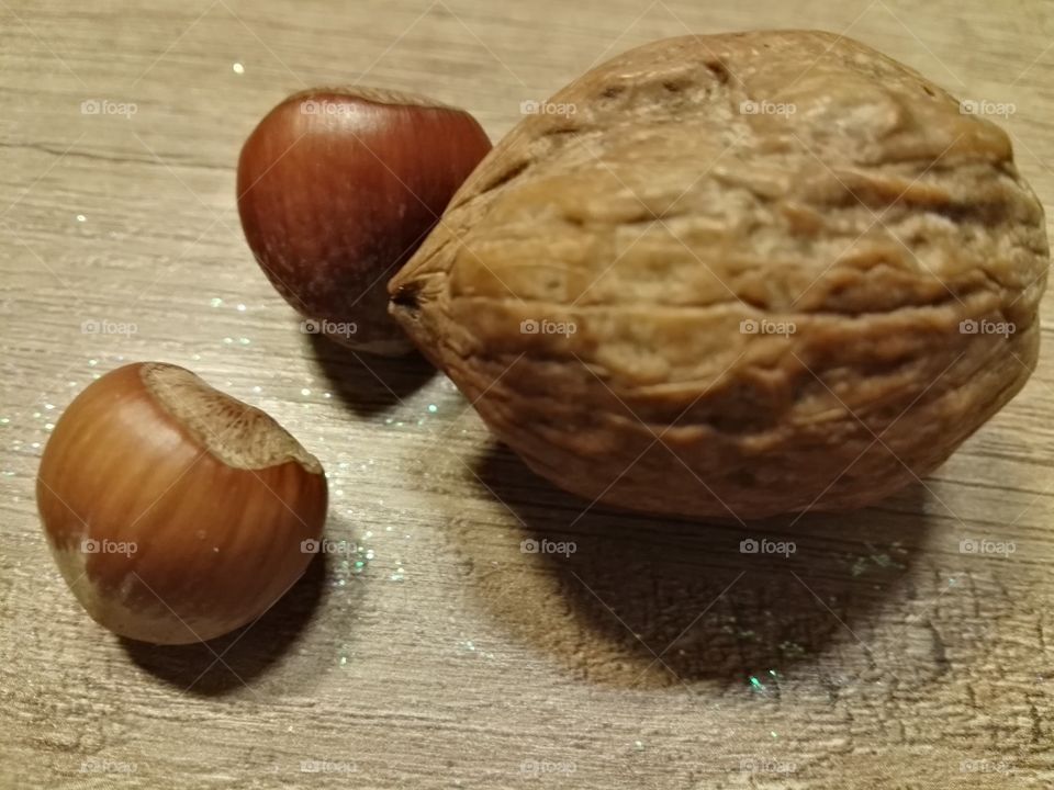 walnut and hazelnuts on wooden table