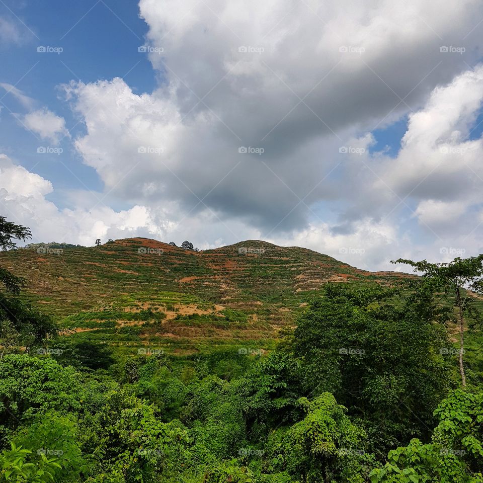 Scenic view of mountain against blue sky