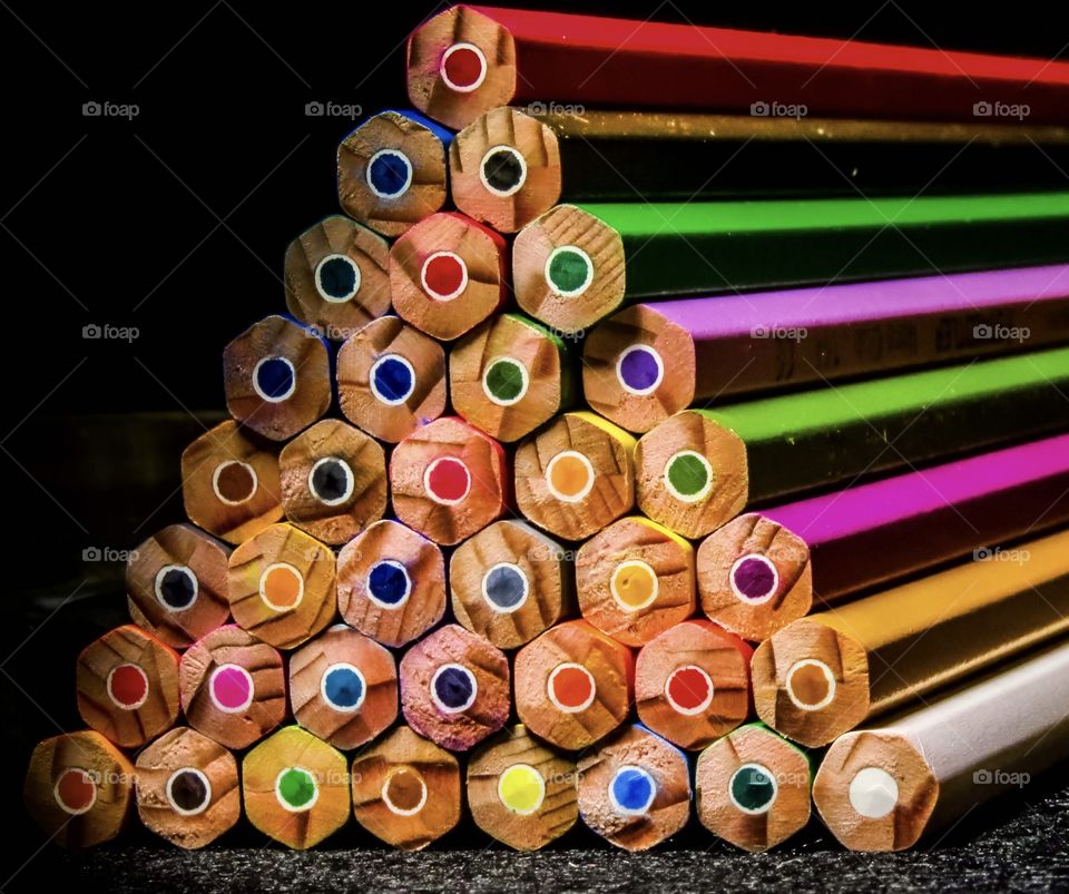 Stacked pyramid of colored pencils