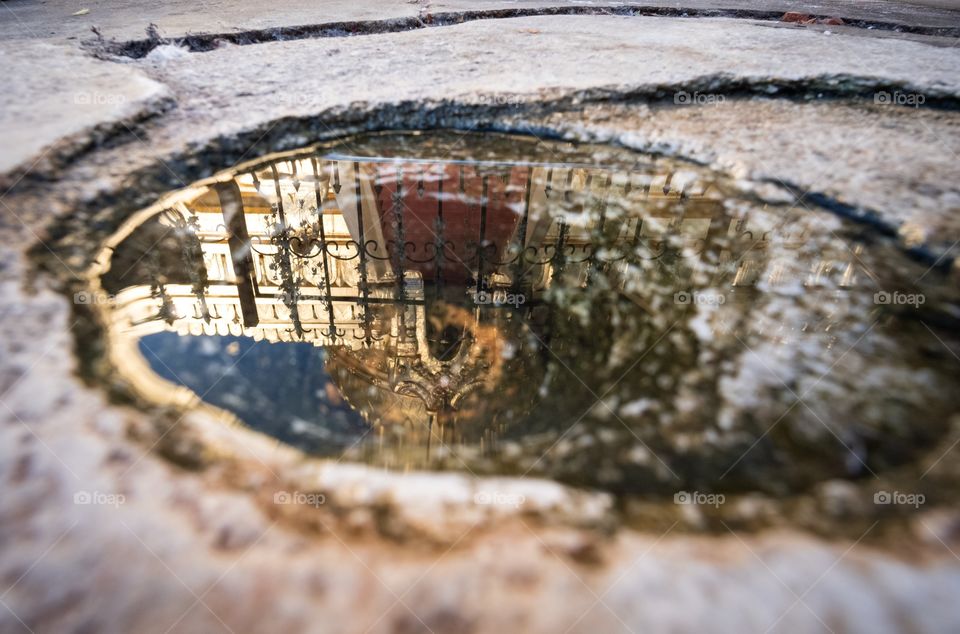 Bagan/Myanmar-April 16 2019:Reflection photo of beautiful Shwezigon Pagoda in the puddle