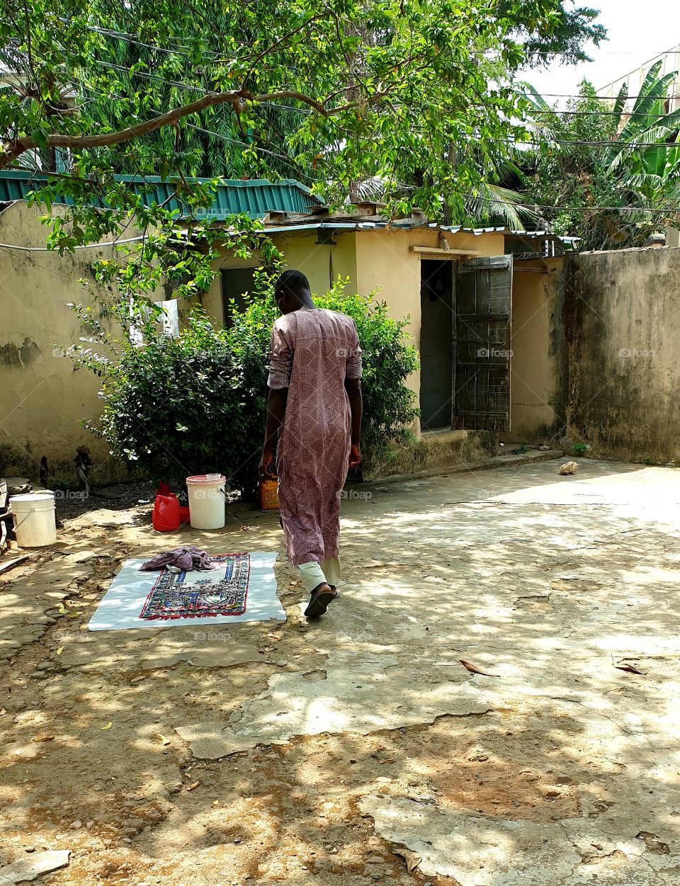 African man walking behind