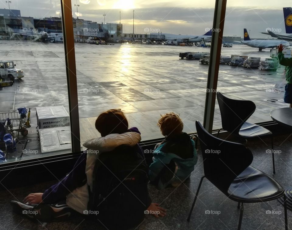 two kids waiting for their flight