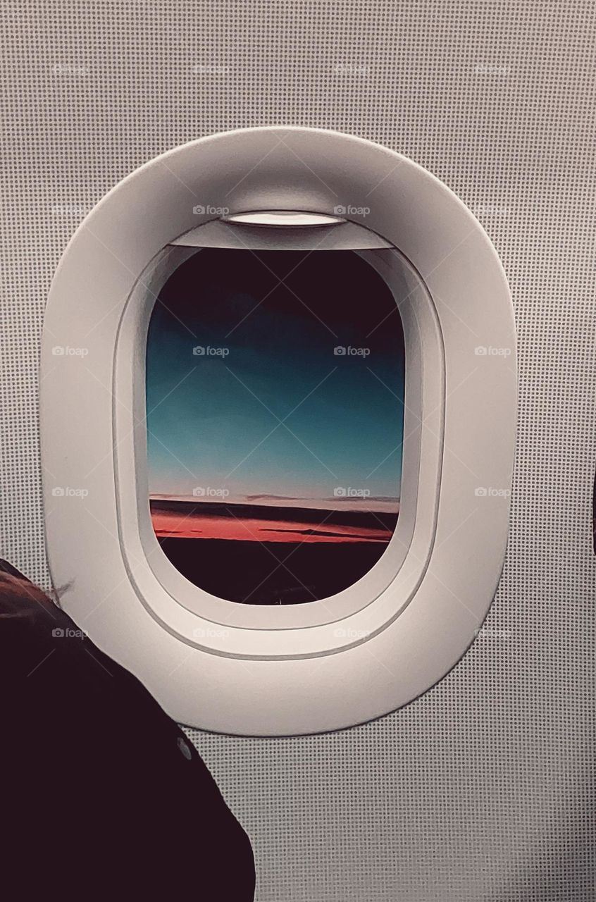 Outlook from the window of a plane in the morning during the sunrise.