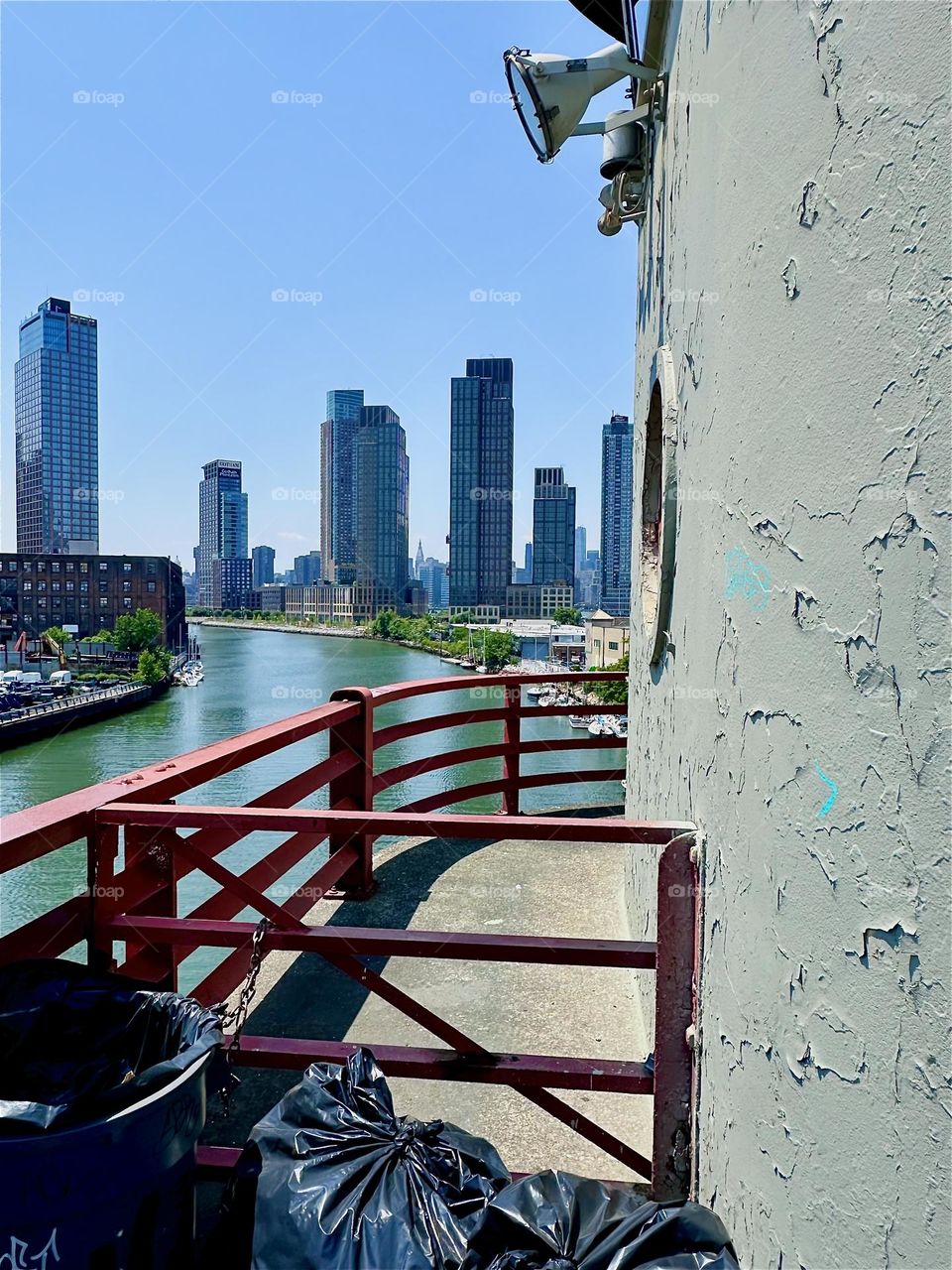 This is the center outpost of the “Pulaski Bridge” at “Newtown Creek” that connects “Greenpoint”, Brooklyn to LIC, Queens. Across the “East River” we see “Greenpoint” on the left, LIC and “Manhattan” on the right. 2024. Hypnotic Productions