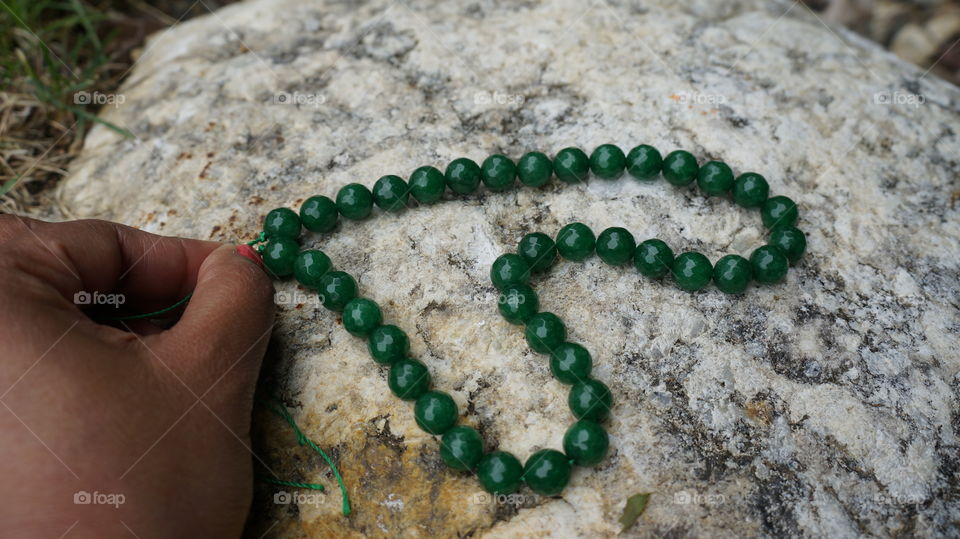 green beads on rock