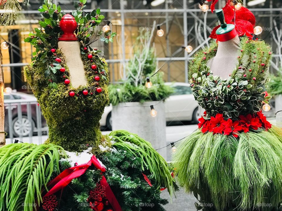 Festive and creative Christmas dresses made out of pine, holly, leaves, and berries.