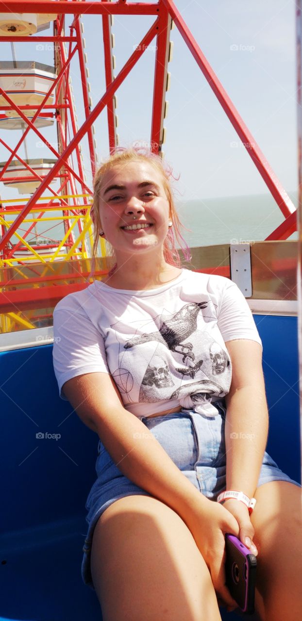 My younger sister smiling for her picture on the ferris wheel at Pleasure Pier in Galveston.