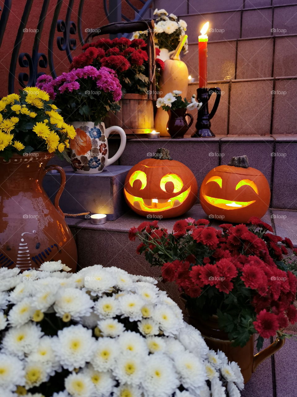 Halloween pumpkin with candles and flowers