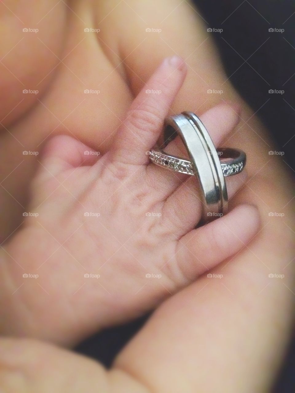 Newborn and parents wedding rings
