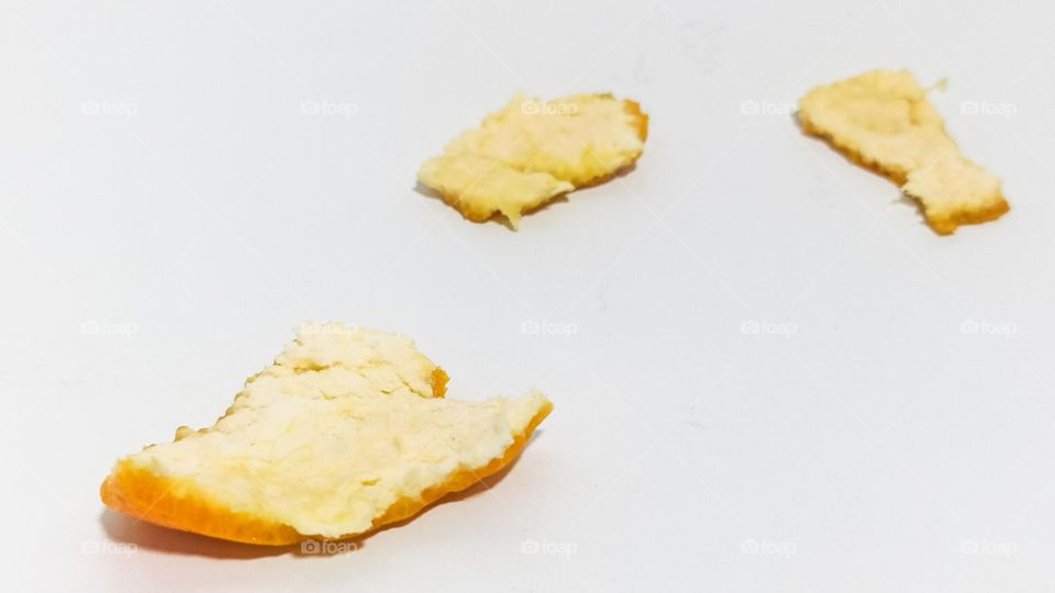 Orange peel on white background isolated in eye level view