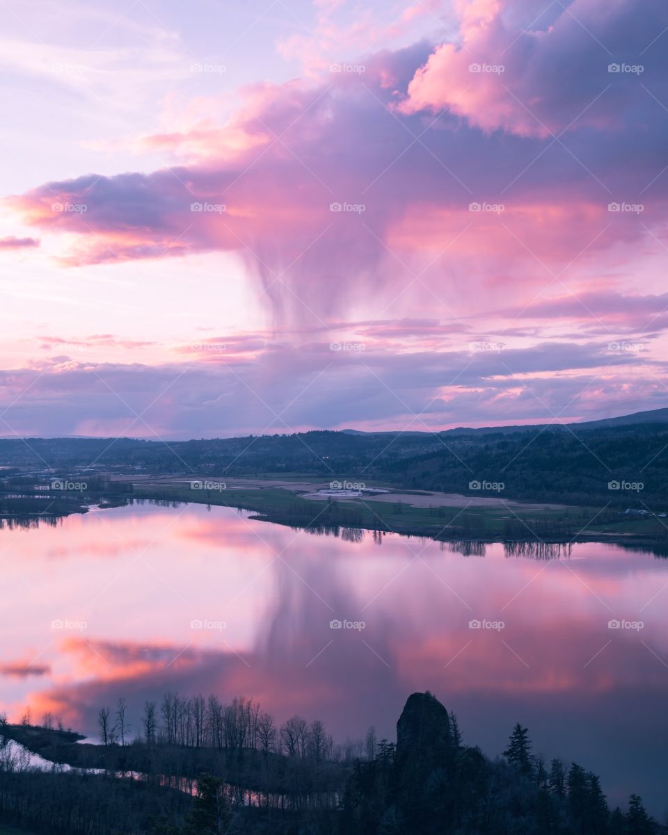 Dramatic rain cloud reflections at sunset 