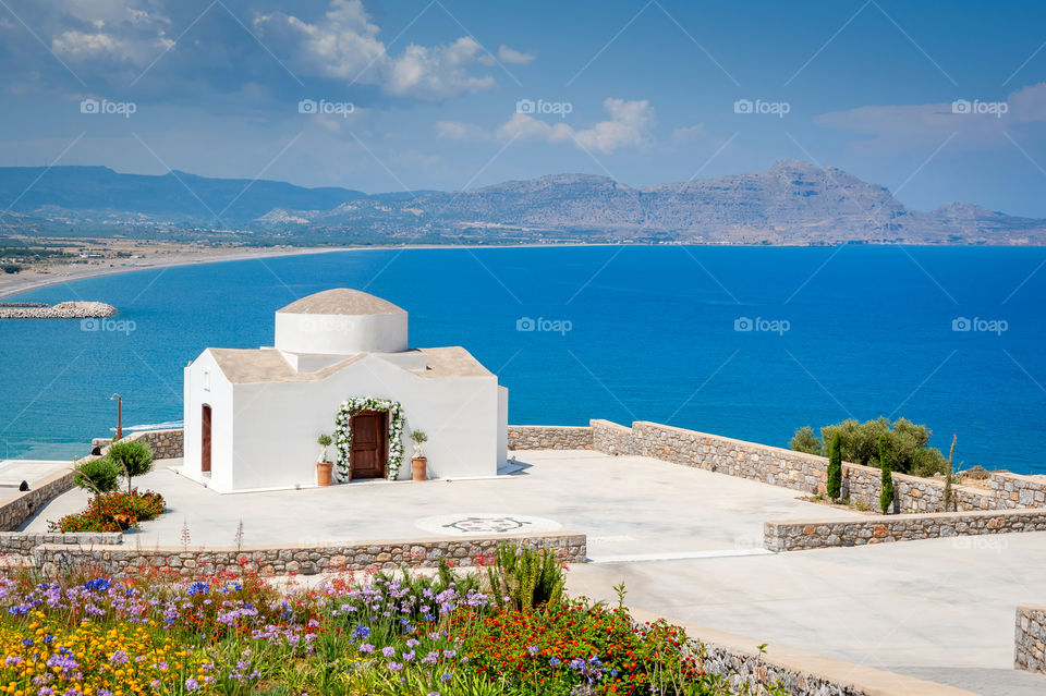 Small whitewashed church at the edge of the sea.