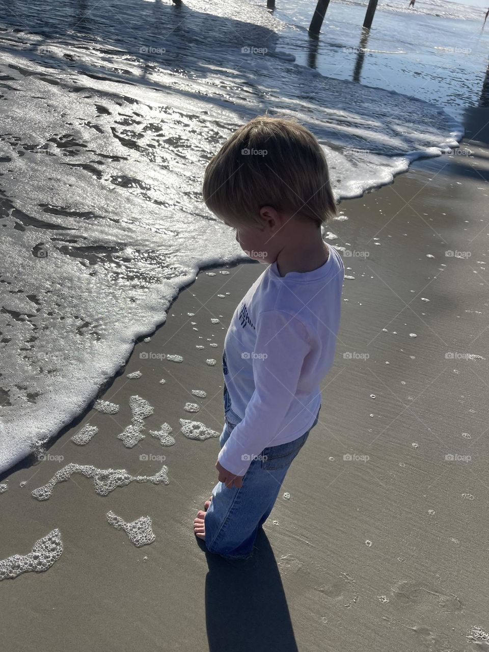 Just a little Boy Seeing the Great Big Atlantic Ocean for the first time from sandy Beach