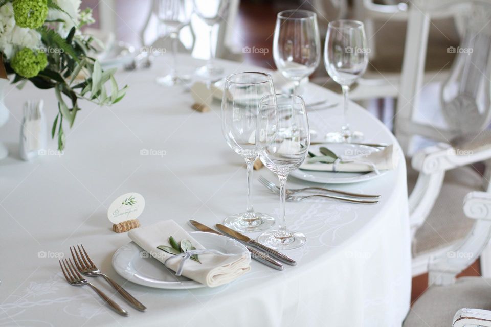 Served wedding table. Simple and beautiful served wedding table. Table served for banquet. Table decorated and served for nice wedding banquet.