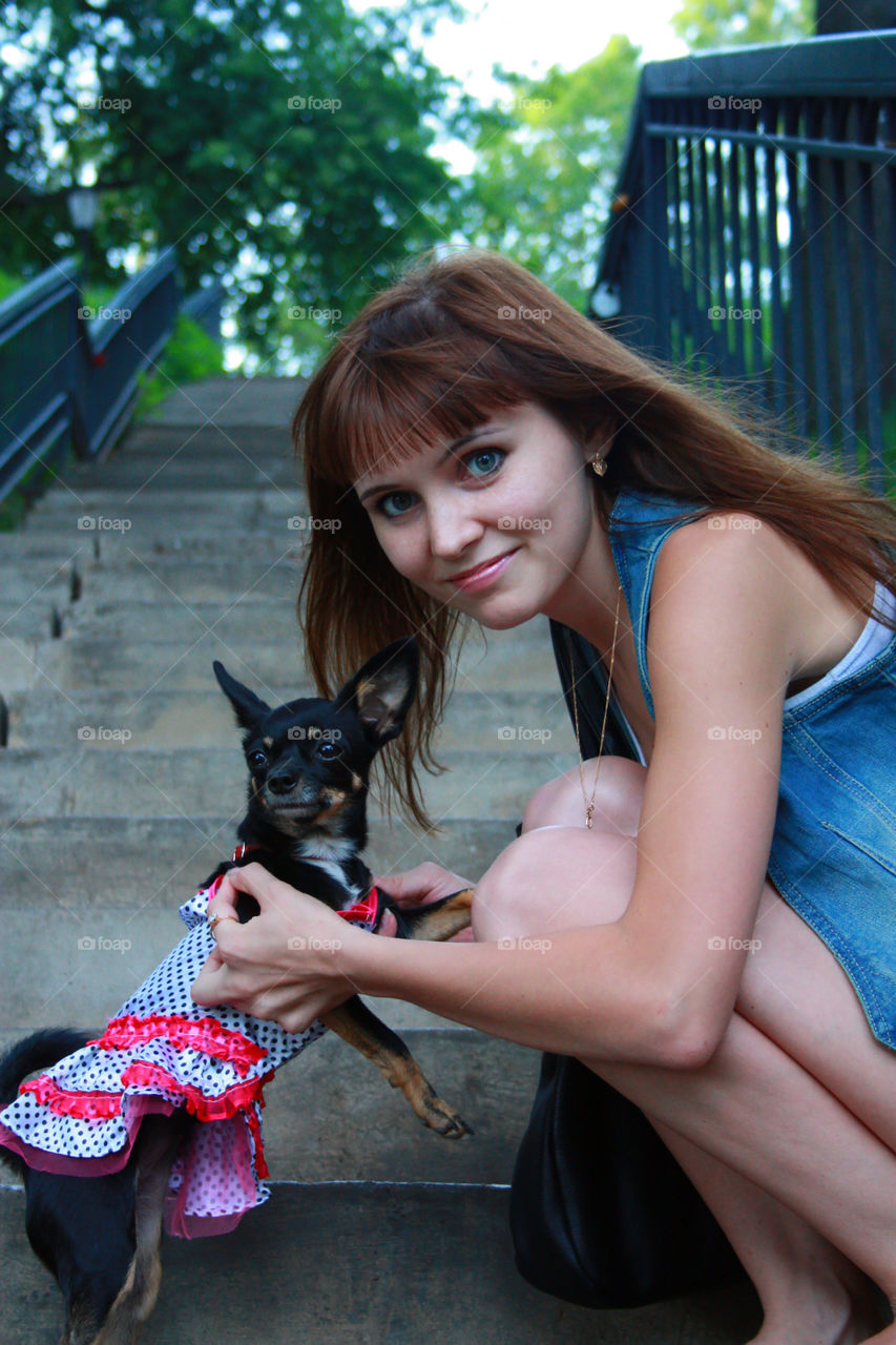 girl and dog walk in the park