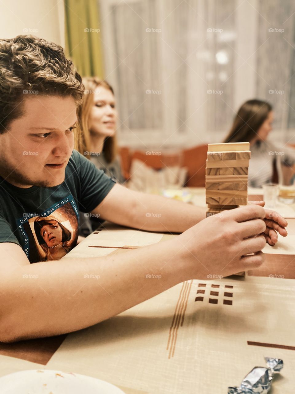 Man playing home game Jenga