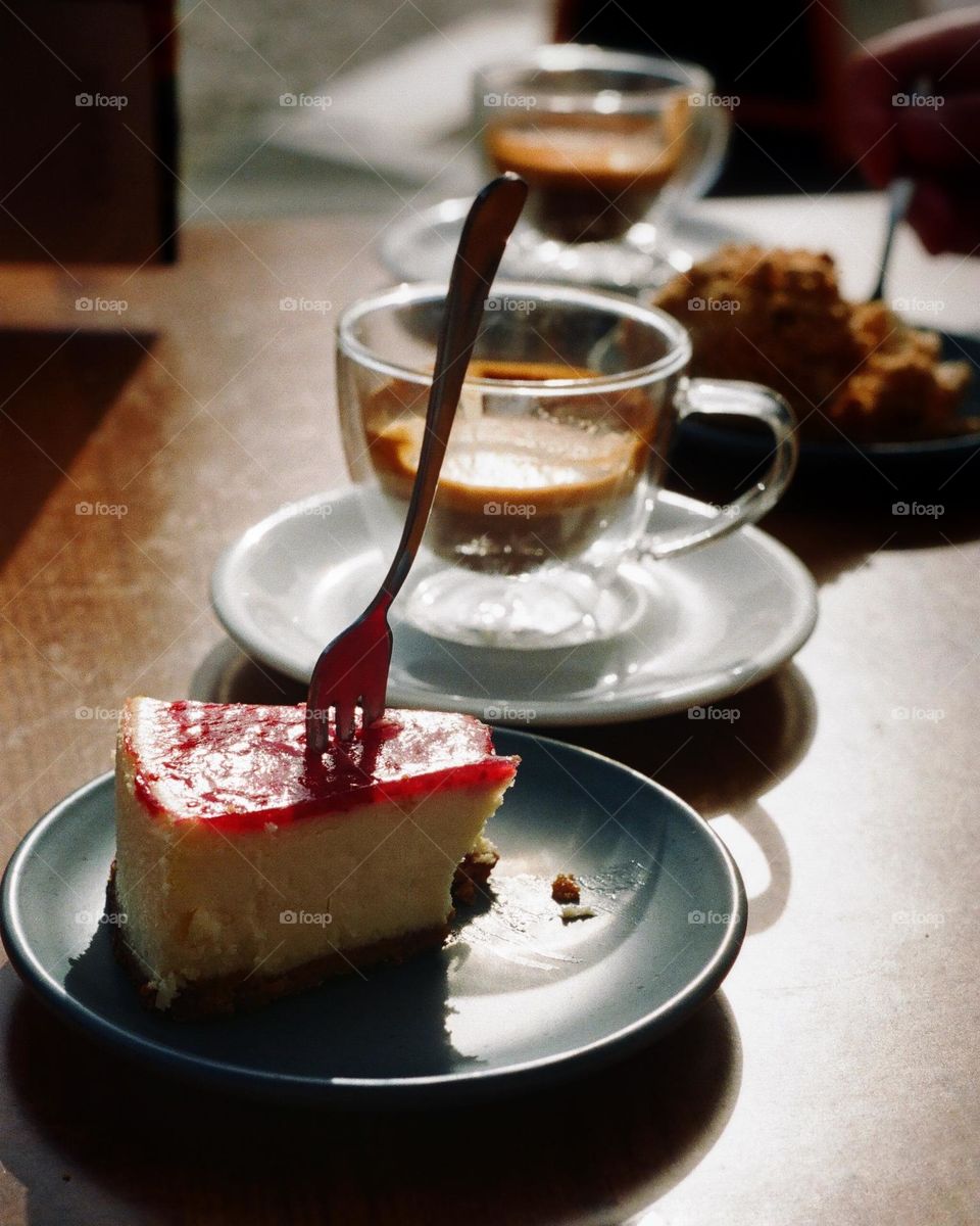 Cake and coffee on the table, outside on a sunny day, café