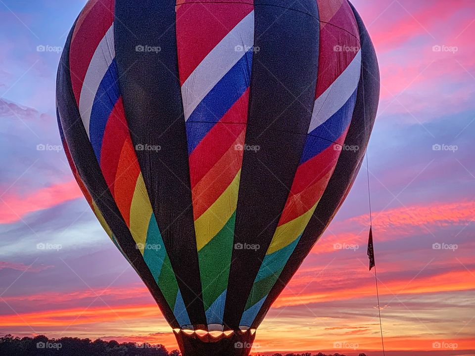 Multicolored hot air balloon and sunset