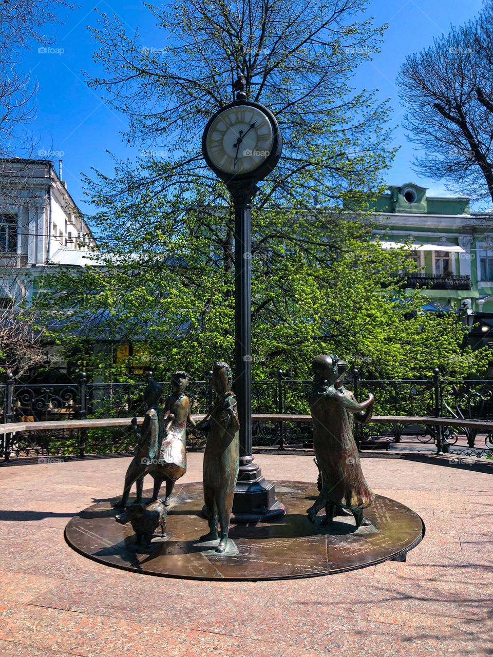 Circle metal monument with figures and clock 