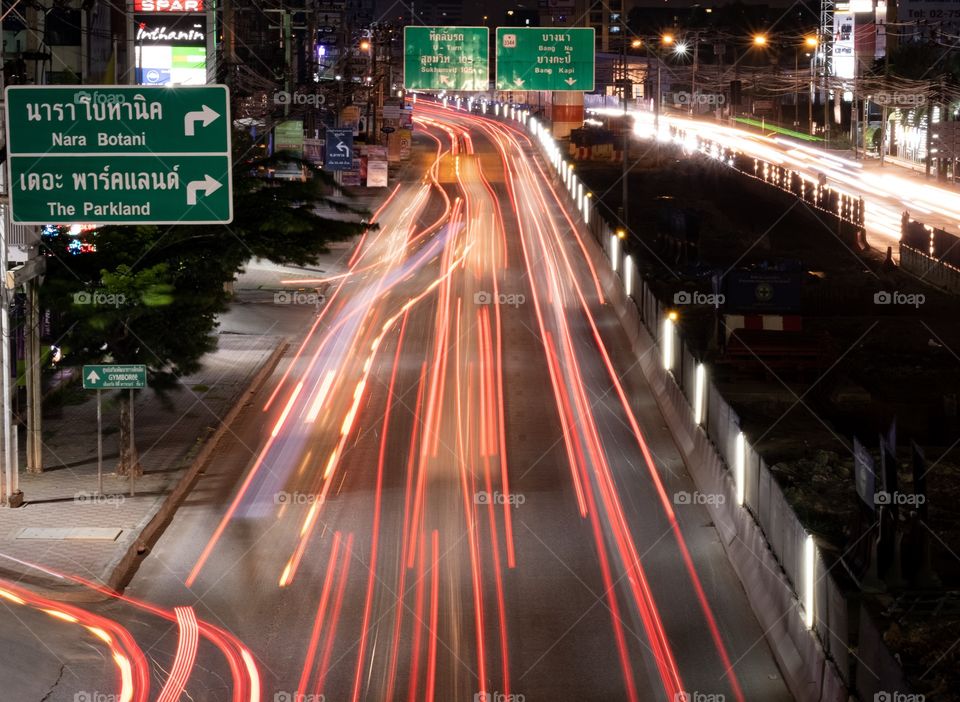 Vehicle lamp make beautiful line on road when drivers are driving back to home in evening 