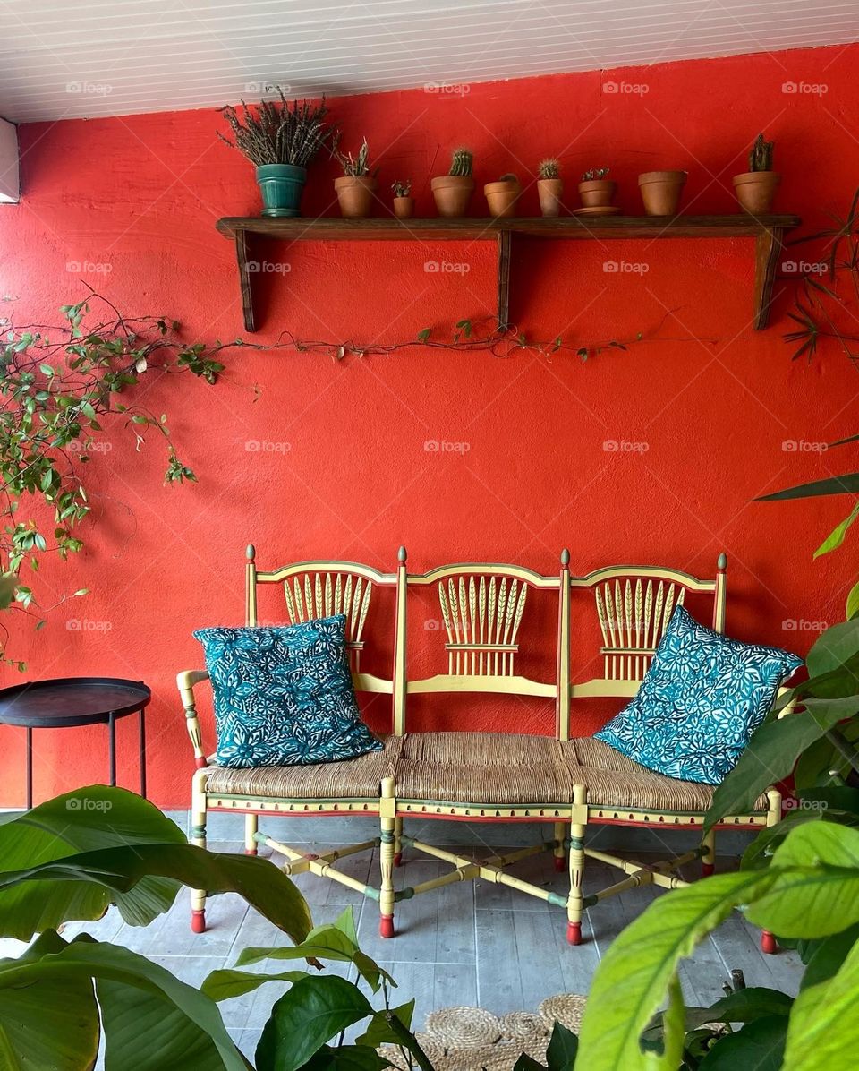 Red patio with chairs and plants 