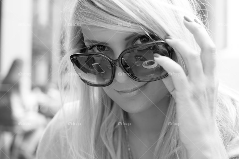 Reflection falling on a woman wearing sunglasses