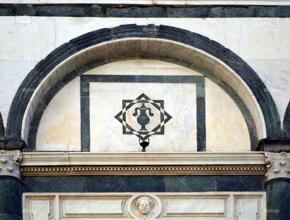 Low angle view of facade detail of church in Empoli, Italy.