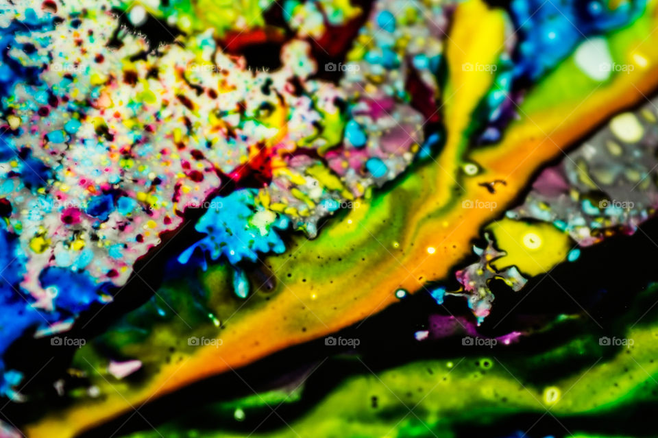 The ink to refill the printer cartridge was spilled onto the white washbasin and the paints blended into abstract drips and patterns.